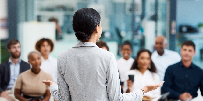 Rearview shot of an unrecognizable businesswoman giving a presentation in the office boardroom