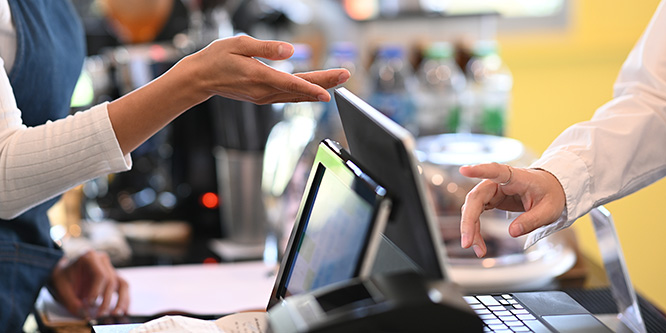 Close up image of customer using checkout screen