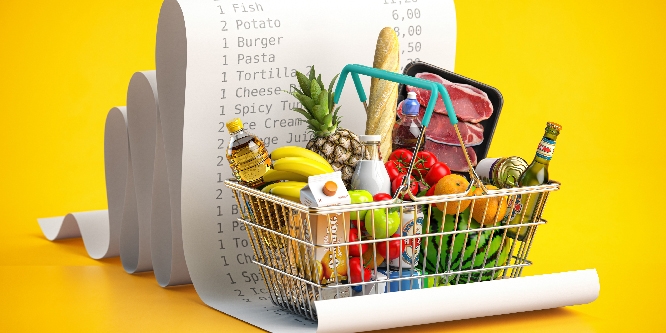 Shopping basket with foods on receipt. Grocery expenses budget, inflation and consumerism concept.