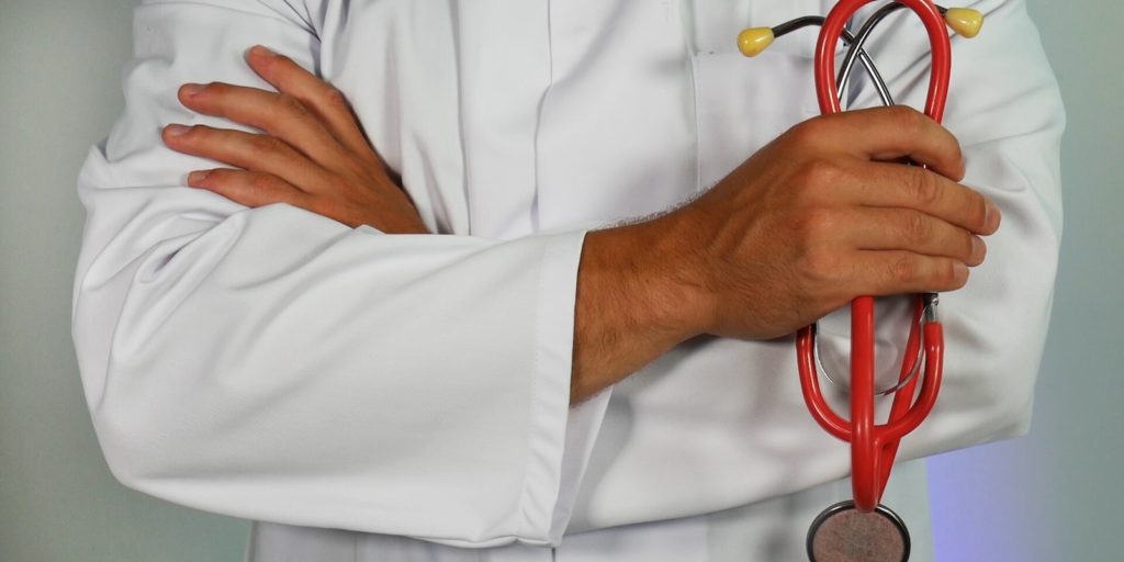 Doctor holding red stethoscope