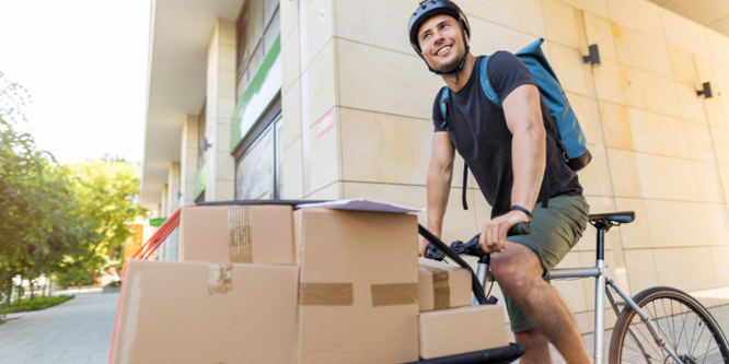 bike courier making delivery on special bike with packages loaded into the front