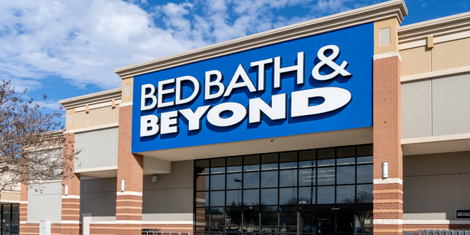 Picture of Bed Bath & Beyond storefront, blue sign and white lettering, taken at a slight angle