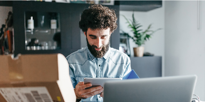 Man looking at tablet and smiling