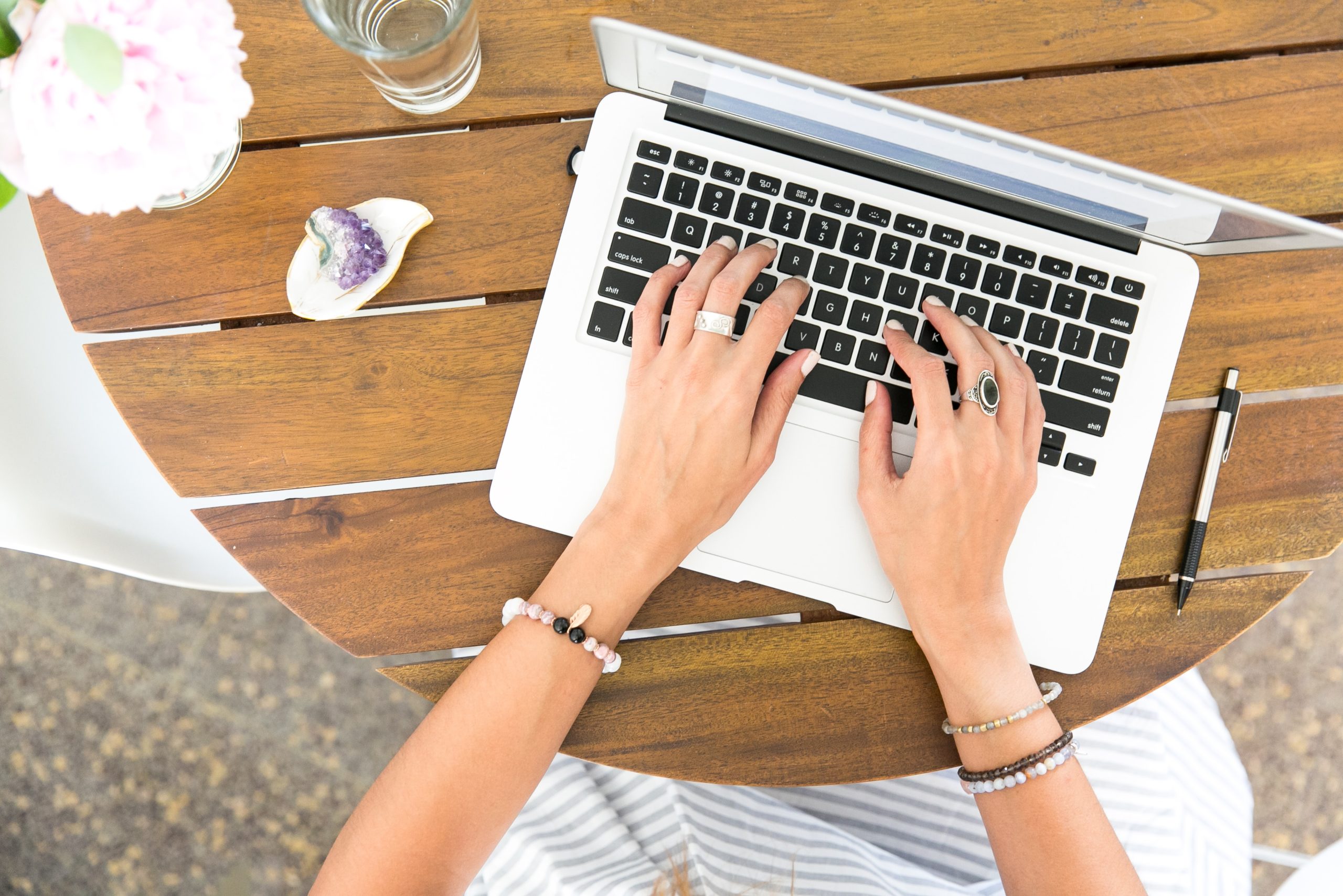 Straight-down image of a woman's hands using laptop